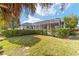 Backyard with screened enclosure and palm trees at 2699 Nw 58Th Terrace, Ocala, FL 34482