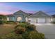 Beautiful single-story home with a three-car garage and well-manicured landscaping at 2699 Nw 58Th Terrace, Ocala, FL 34482