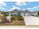 Single-story house with a three-car garage and nicely landscaped yard at 2699 Nw 58Th Terrace, Ocala, FL 34482