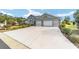 Single story home with a three car garage and a long driveway at 2699 Nw 58Th Terrace, Ocala, FL 34482