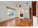 Living room with hardwood floors, fireplace, and large window at 2699 Nw 58Th Terrace, Ocala, FL 34482