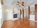 Spacious living room featuring hardwood floors, a fireplace, and high ceilings at 2699 Nw 58Th Terrace, Ocala, FL 34482