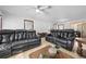 Living room with two black reclining sofas and a coffee table at 36 Cedar Tree Ter, Ocala, FL 34472