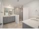 Bathroom with grey vanity and walk-in shower at 5886 Sw 78Th Avenue Rd, Ocala, FL 34474