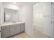 Clean bathroom with grey vanity, a bathtub, and a mirrored medicine cabinet at 5886 Sw 78Th Avenue Rd, Ocala, FL 34474