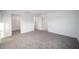 Bright bedroom with grey carpet and attached bathroom at 5886 Sw 78Th Avenue Rd, Ocala, FL 34474
