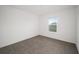 Simple bedroom with neutral carpeting and a window at 5886 Sw 78Th Avenue Rd, Ocala, FL 34474
