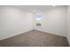 Bright bedroom with neutral carpeting and a window offering natural light at 5886 Sw 78Th Avenue Rd, Ocala, FL 34474