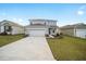 Two-story house with gray siding, stone accents, and a two-car garage at 5886 Sw 78Th Avenue Rd, Ocala, FL 34474
