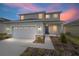 Two-story house with gray siding, stone accents, and a two-car garage at 5886 Sw 78Th Avenue Rd, Ocala, FL 34474
