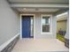 A blue front door with sidelights welcomes you into the home at 5886 Sw 78Th Avenue Rd, Ocala, FL 34474