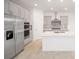 Modern kitchen with stainless steel appliances and an island at 5886 Sw 78Th Avenue Rd, Ocala, FL 34474