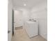Laundry room with side-by-side washer and dryer and overhead shelving at 5886 Sw 78Th Avenue Rd, Ocala, FL 34474
