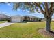 House exterior showcasing a large tree and front yard at 6330 Sw 48Th Ave, Ocala, FL 34474