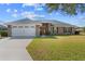 Brick house with a two-car garage and well-maintained lawn at 6330 Sw 48Th Ave, Ocala, FL 34474