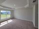 Spacious bedroom with large window and carpet flooring at 7695 Sw 103Rd Loop, Ocala, FL 34476