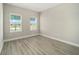 Bright bedroom with wood-look floors and two windows at 8456 Sw 99Th Ave, Ocala, FL 34481