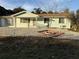 Ranch-style home with light blue siding, gravel landscaping, and screened porch at 8849 Sw 109Th St, Ocala, FL 34481