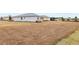 Large backyard with dried grass and partial view of home at 8916 Sw 78Th Street Rd, Ocala, FL 34481