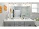 Modern bathroom with double sinks and a large vanity mirror at 8916 Sw 78Th Street Rd, Ocala, FL 34481