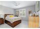 Charming bedroom with a queen bed, dresser and natural light at 8916 Sw 78Th Street Rd, Ocala, FL 34481