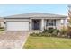 One story home with gray siding, white garage door, and landscaped front yard at 8916 Sw 78Th Street Rd, Ocala, FL 34481