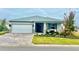 One-story home with gray siding, paver driveway, and landscaped yard at 8916 Sw 78Th Street Rd, Ocala, FL 34481