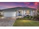 One-story home with gray siding, white garage door, and landscaped front yard at 8916 Sw 78Th Street Rd, Ocala, FL 34481