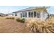 House exterior showcasing back sunroom and yard at 8916 Sw 78Th Street Rd, Ocala, FL 34481