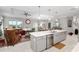 Open concept kitchen with island, stainless steel appliances, and white cabinets at 8916 Sw 78Th Street Rd, Ocala, FL 34481