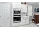 Built-in wall oven and microwave, white cabinets, and stainless steel appliances at 8916 Sw 78Th Street Rd, Ocala, FL 34481