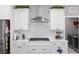 Gas cooktop with stainless steel range hood and white cabinets at 8916 Sw 78Th Street Rd, Ocala, FL 34481