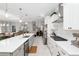 Modern kitchen with stainless steel appliances, white cabinets, and an island at 8916 Sw 78Th Street Rd, Ocala, FL 34481