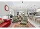 Open living room with green armchairs and a red couch, looking towards kitchen at 8916 Sw 78Th Street Rd, Ocala, FL 34481