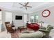 Cozy living room featuring a red couch and comfortable armchairs at 8916 Sw 78Th Street Rd, Ocala, FL 34481