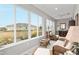 Sunroom with wicker furniture, large windows, and backyard views at 8916 Sw 78Th Street Rd, Ocala, FL 34481