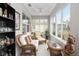 Relaxing sunroom with wicker furniture and large windows at 8916 Sw 78Th Street Rd, Ocala, FL 34481