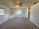 Large carpeted bedroom with ceiling fan and window at 9669 Se 174Th Place Rd, Summerfield, FL 34491