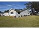 Side view of a single story home showcasing a large backyard at 9669 Se 174Th Place Rd, Summerfield, FL 34491