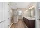 Spa-like bathroom with double sinks, walk-in shower, and hardwood floors at 9725 Sw 108Th Terrace Rd, Ocala, FL 34481