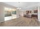 Dining room with kitchen view, hardwood floors, and access to patio at 9725 Sw 108Th Terrace Rd, Ocala, FL 34481