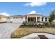 Two-car garage, landscaped yard, and a paved driveway at 9725 Sw 108Th Terrace Rd, Ocala, FL 34481