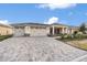 Two-car garage and a large paved driveway at 9725 Sw 108Th Terrace Rd, Ocala, FL 34481