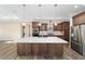 Modern kitchen with island, stainless steel appliances, and hardwood floors at 9725 Sw 108Th Terrace Rd, Ocala, FL 34481