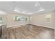 Spacious living room with large windows and wood-look flooring at 9725 Sw 108Th Terrace Rd, Ocala, FL 34481