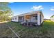 Home's back with a screened patio and grassy yard at 9739 Sw 79Th Lane Rd, Ocala, FL 34481