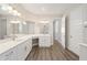 Bathroom with double vanity, white cabinets, and a large mirror at 9739 Sw 79Th Lane Rd, Ocala, FL 34481