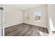 Bedroom with wood-look floors and two windows at 9739 Sw 79Th Lane Rd, Ocala, FL 34481
