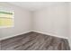 Empty bedroom with wood-look floors and window at 9739 Sw 79Th Lane Rd, Ocala, FL 34481