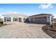 Single-story home with a three-car garage and paver driveway at 9739 Sw 79Th Lane Rd, Ocala, FL 34481